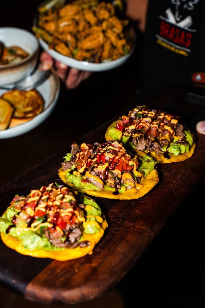 Plates of churrasco, yuca, and tostones on display